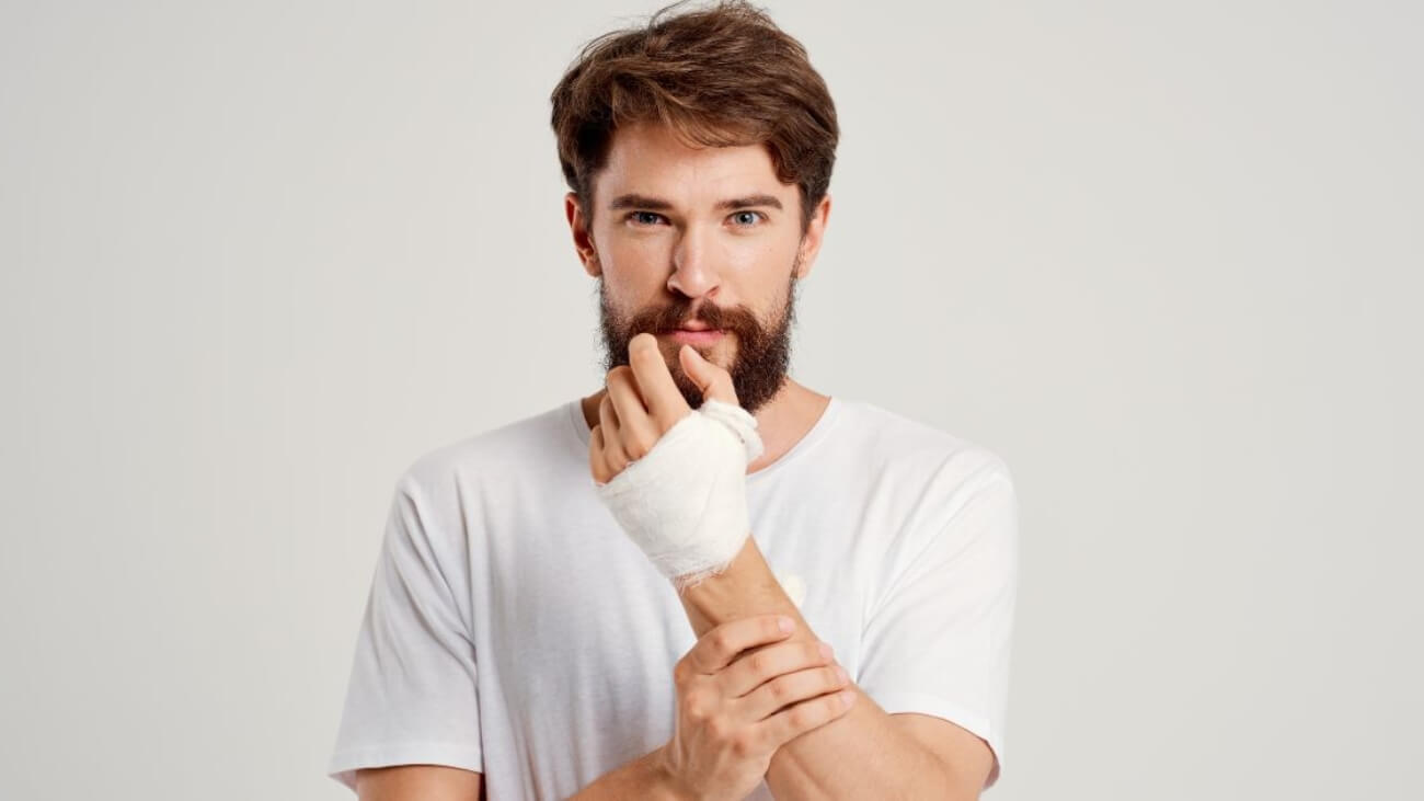 Man holding injured arm