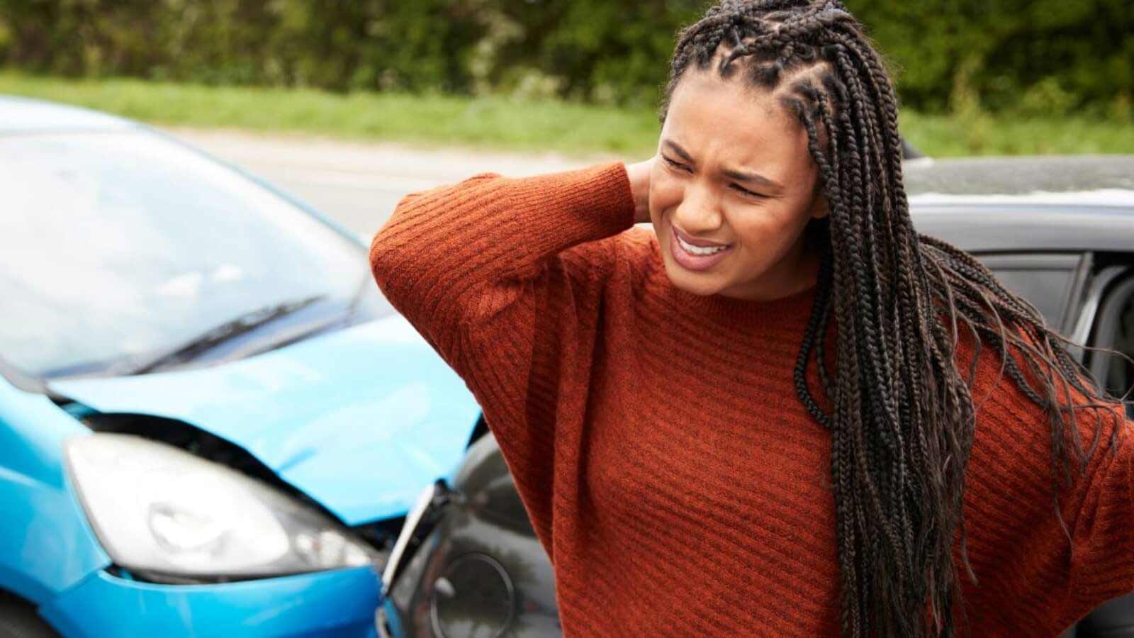 Woman holding neck after car accident