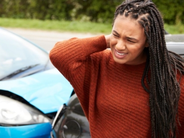 Woman holding neck after car accident