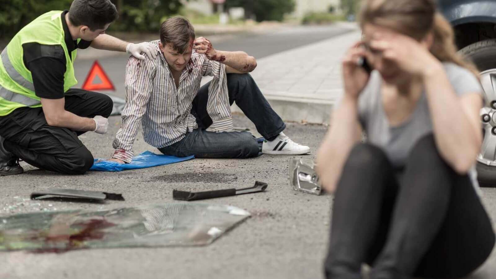People sitting on the road after car accident
