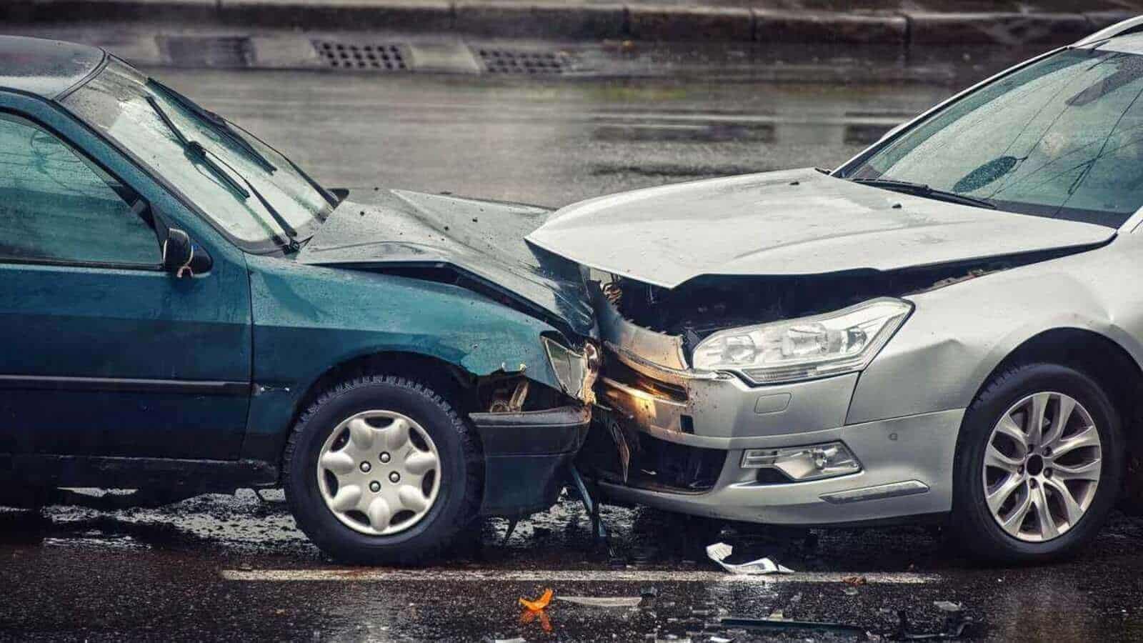 Car accident on wet road during rain, head on collision side view.